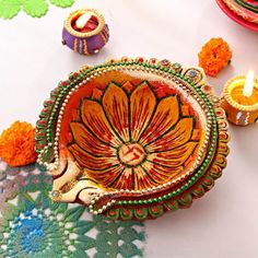 an ornately decorated dish with candles on the table