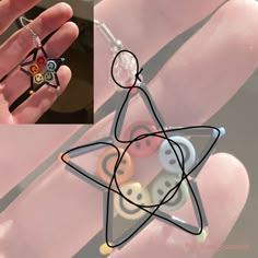 a hand holding a small star shaped object with buttons on it's fingers and an image of a person wearing a ring