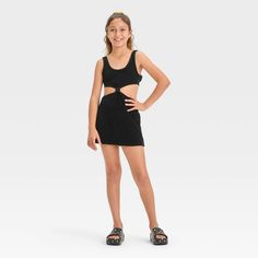 Your kiddo can layer their swimsuit while lounging on the beach or returning home from their swim session with this Solid Terry Cover-Up Dress from art class™. This sleeveless cover-up dress in a solid color features a center knot detail along with cutout sides and back for a stylish, breezy look. The cotton-blend terry fabric offers a cool and comfortable fit, while the pullover style allows for easy wear. Plus, the UPF 50+ rated finish offers added protection from UV rays. Welcome to art class Summer School Mini Dress, Sleeveless Summer School Dress, Playful Black Summer Dress, Summer Stretch Dresses For Playwear, Stretch Summer Dresses For Playwear, Stretch Dresses For Summer Playwear, Black Summer Beachwear Swimwear, Casual Black Swim Dress, Crochet Cover Up