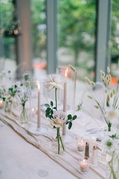 the table is set with candles and flowers