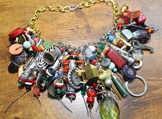 a close up of a necklace on a table with beads and other items attached to it