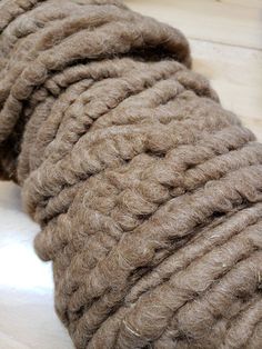 a close up of a rope on the ground with wood flooring in the background