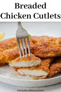 a plate with breaded chicken cutlets on it and a fork in the middle