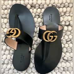 Never Worn Gucci Mormont Double Gg Black Leather T Straps Sandals Featuring Gold Hardware And Embossed Bee At Outsole Size 37 With Bag Made In Italy Gucci Luxury Sandals With Single Toe Strap, Gg Sandals, Gucci Luxury Sandals With Buckle Closure, Gucci Slides Outfit Women, Gucci Slides Outfit, Fancy Slippers, Gucci Open-toe Sandals With Padded Heel, Gucci Shoes Women, Straps Sandals