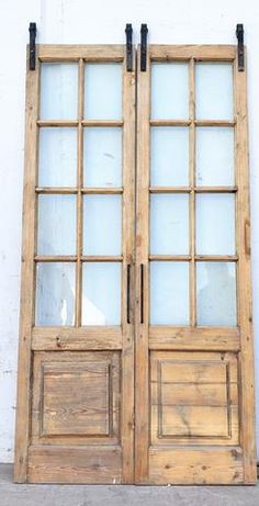 an old wooden double door with glass panels