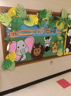 a bulletin board with animals and plants on it in a classroom hallway at st john's catholic school