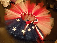 a red, white and blue tutu skirt with stars on it sitting on a table