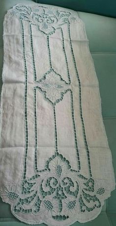 an old white table cloth with green trim