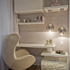 a white chair sitting in front of a window next to a shelf filled with books