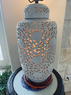 a white lantern sitting on top of a table