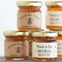 four jars of honey with labels on them