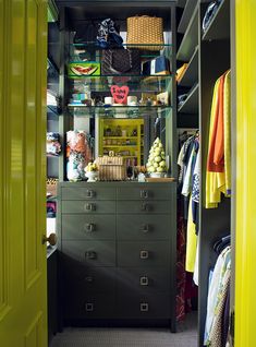 the closet is full of clothes and other items, including an armoire with drawers