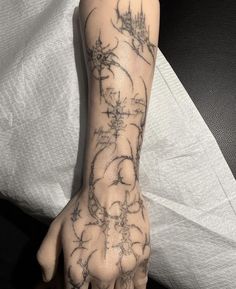 a person's hand with a tattoo on it