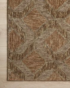 a brown and tan area rug on top of a wooden floor