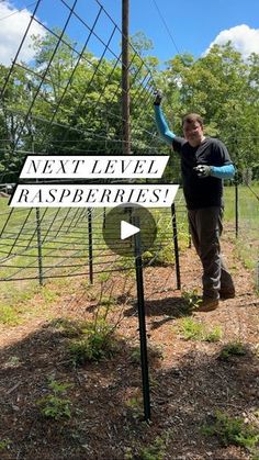 a man standing next to a sign that says next level raspberries