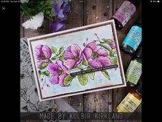 a card with some flowers on it next to bottles and other crafting supplies,