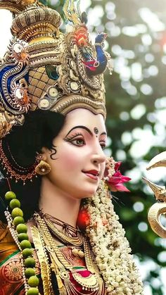 a close up of a person wearing a costume and headpiece with jewelry on it