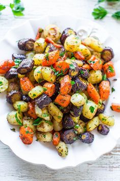 a white bowl filled with potatoes and carrots