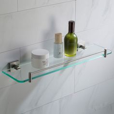 a glass shelf with two bottles on it