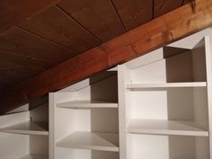 the shelves are all white and have no doors on them, but there is wood in the ceiling