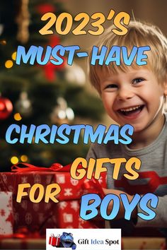 a young boy holding a christmas present with the words, must have christmas gifts for boys