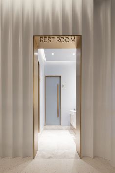 the entrance to a rest room with white walls