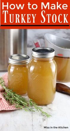 two jars filled with turkey stock sitting on top of a table