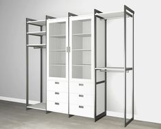 an empty room with three white closets and two open shelves on the wall next to each other