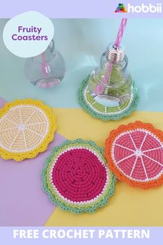 three crocheted coasters with fruity coasters on them