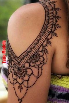 the back of a woman's shoulder with an intricate design on it