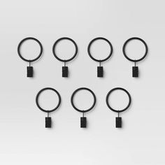 eight circular rings with black handles on white background