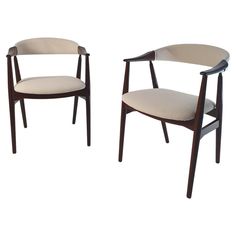 two chairs, one with a beige upholstered seat and the other with a dark wood frame