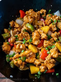 a stir fry with chicken, peppers and onions