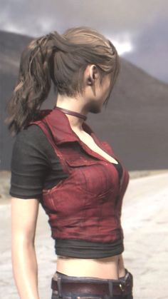 a woman standing in the desert with her back to the camera, wearing a red shirt and black pants