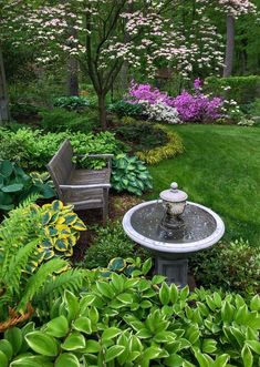 a small fountain in the middle of a garden