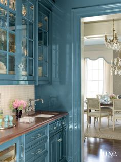 an image of a kitchen setting with blue cabinets and wood counter tops in the center