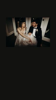 a man in a tuxedo sitting next to a woman in a wedding dress