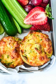 two muffins in a tray with fresh fruit and vegetables on the side text reads savory bacon and vegetable muffins for kids