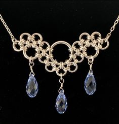 "This elegant chainmaille necklace is an interpretation off of the Stepping Stones weave created by Corvus Chainmaille.   The pendant is made from sterling silver filled jump rings and genuine Swarovski crystal briolettes, and is a beautiful, feminine interpretation on chainmaille. This unique pendant is sure to be a conversation starter!  The pendant measures 2\" across and is 1.5\" long at the center point. The Swarovski crystals come in 17 different colors* so you can completely personalize t Jump Rings Tutorial, Jump Ring Necklace, Chainmaille Ring, Chain Maille Necklace, Chainmaille Jewelry Patterns, Chainmaille Tutorial, Chainmaille Necklace, Jump Ring Jewelry, Wire Wrap Jewelry Designs