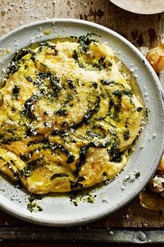 an omelet with spinach and cheese in a white bowl