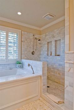 a large bathroom with a walk in shower next to a bathtub