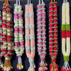 flowers and garlands are hanging on the wall