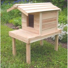 a small wooden dog house in the grass