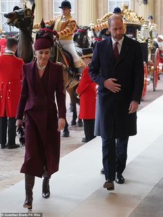 the queen and prince are walking down the hall