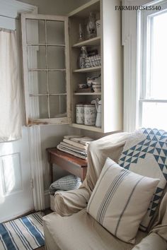 a living room filled with furniture next to a window