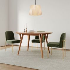 a dining room table with two chairs and a white rug on the floor next to it