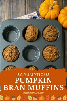 pumpkin bran muffins in a muffin pan on a wooden table with an orange pumpkin