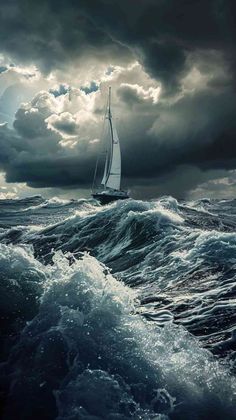 a sailboat in the middle of an ocean with dark clouds above and below it