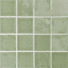 a green tiled wall with white grouting