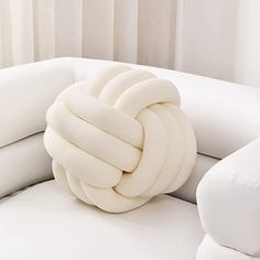 a white couch with a knot on it